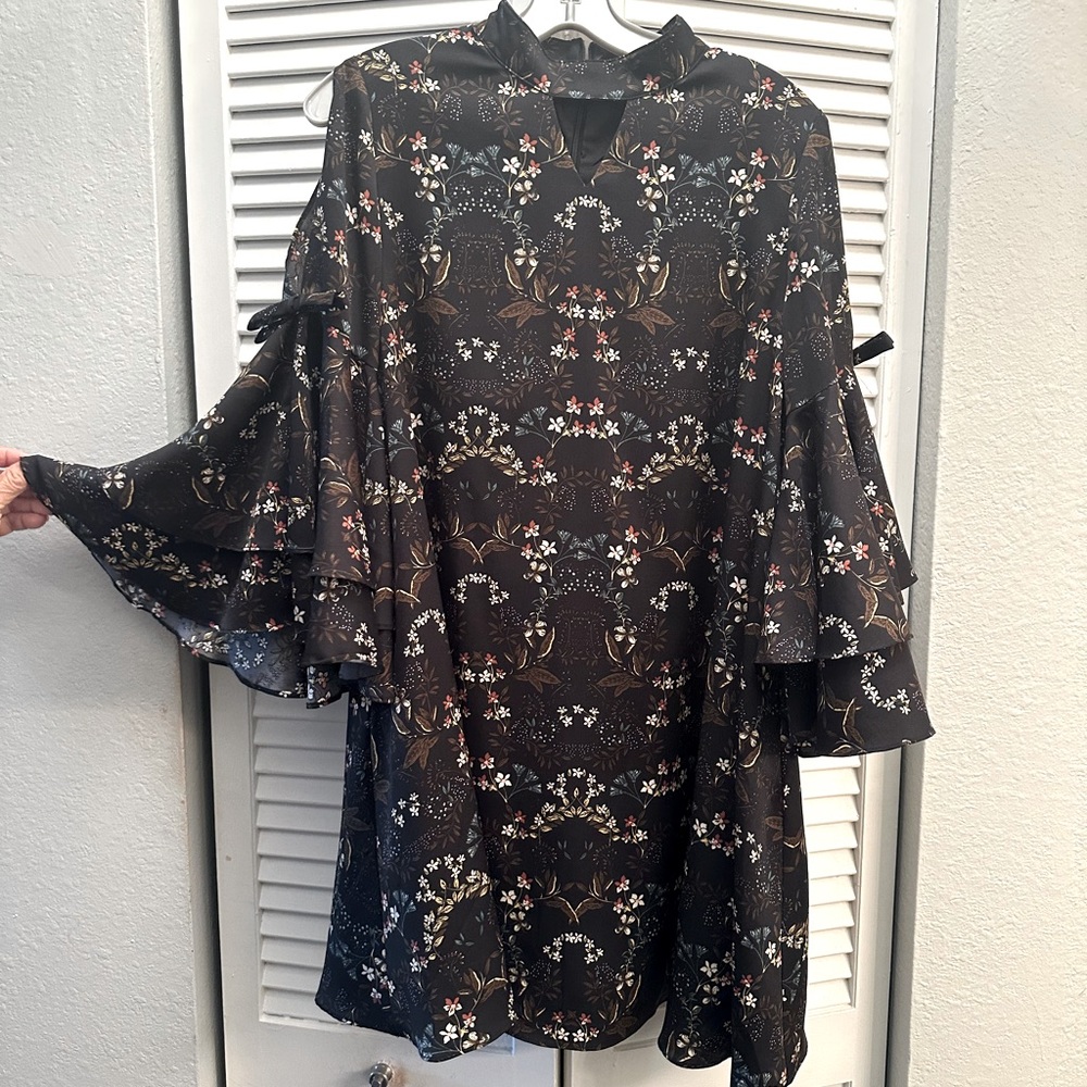 Flowing dress above knee peek a boo bell sleeve bow tie and kimono style neck.